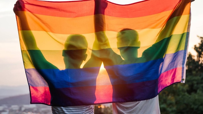 couple-silhouette-holding-rainbow-flag.jpg