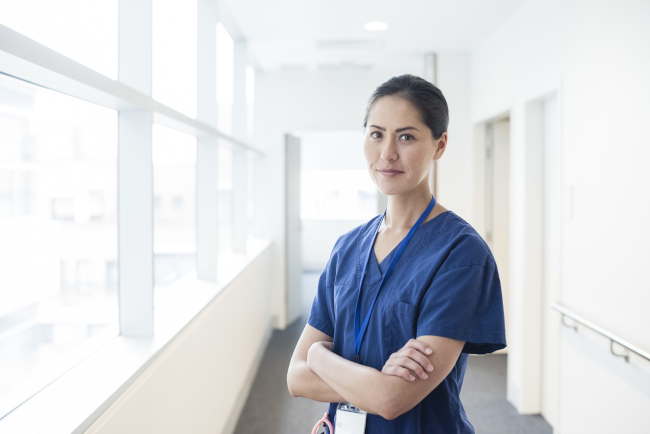2020-07 Nurse standing in hospital corridor 650x434.jpg